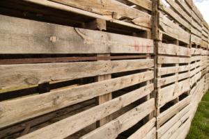 A wooden pallet privacy wall is an eco-friendly and budget-friendly way to block your neighbor’s view into your yard.